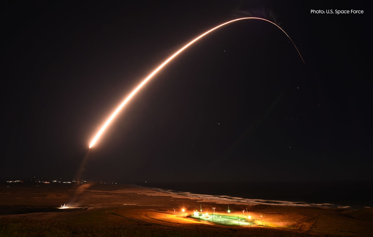 A missile followed by a streak launching in a dark sky