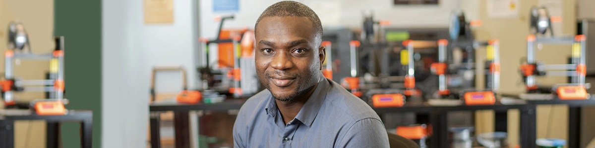 black man smiling in a lab
