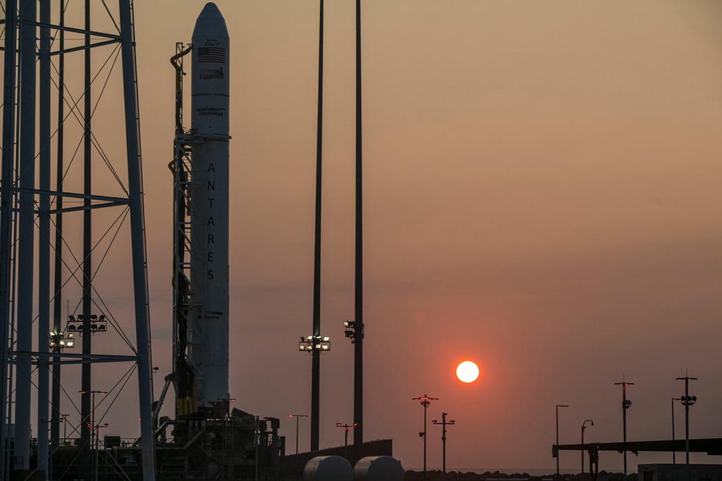 The Antares rocket waits to launch at sunrise