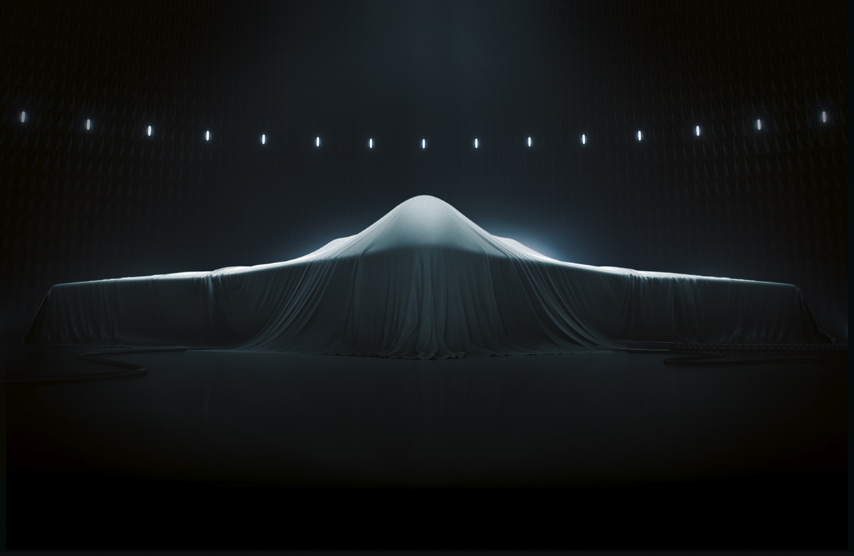 Image of an aircraft with a fabric drape covering it, white lights in the background and
