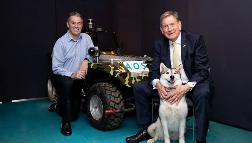 two males with dog and ATV