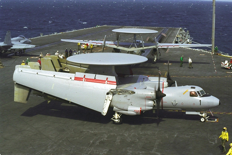 aircraft with wings folded on aircraft carrier