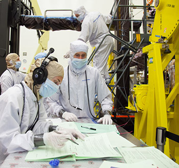 technicians in bunnysuits working on spacecraft