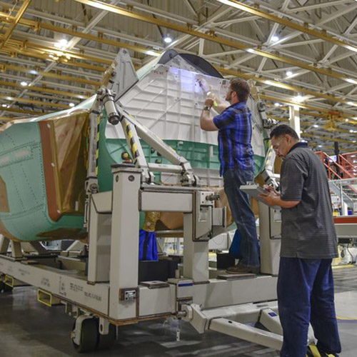 Two techicians working on F-35 center fuselage