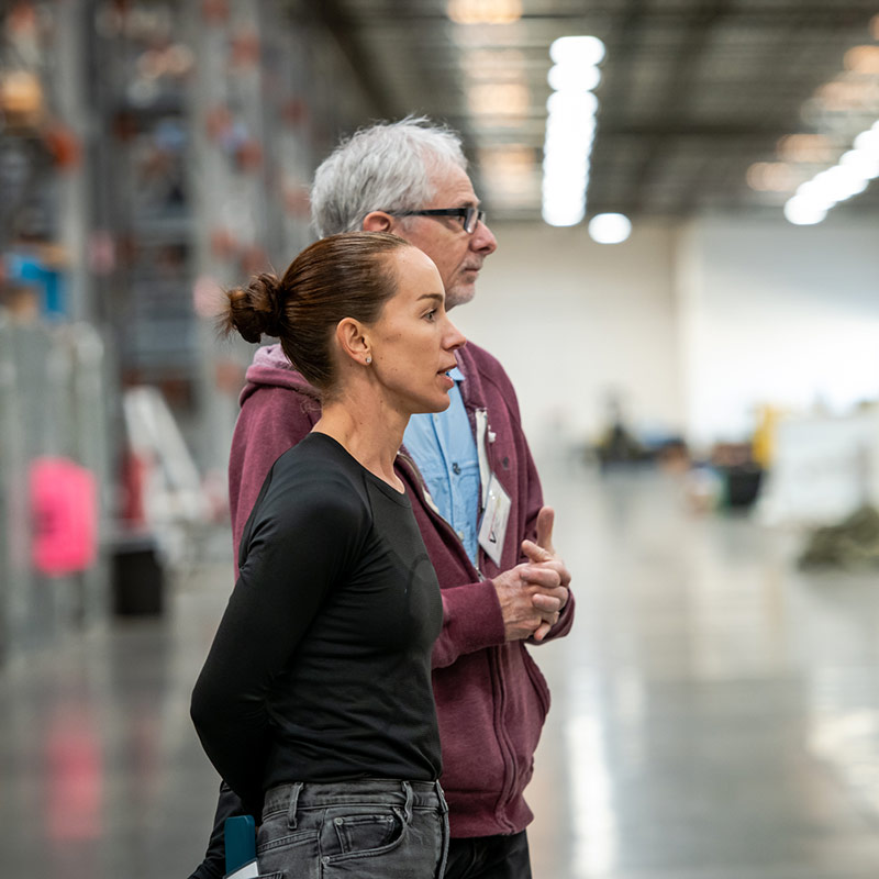woman and man standing in warehouse