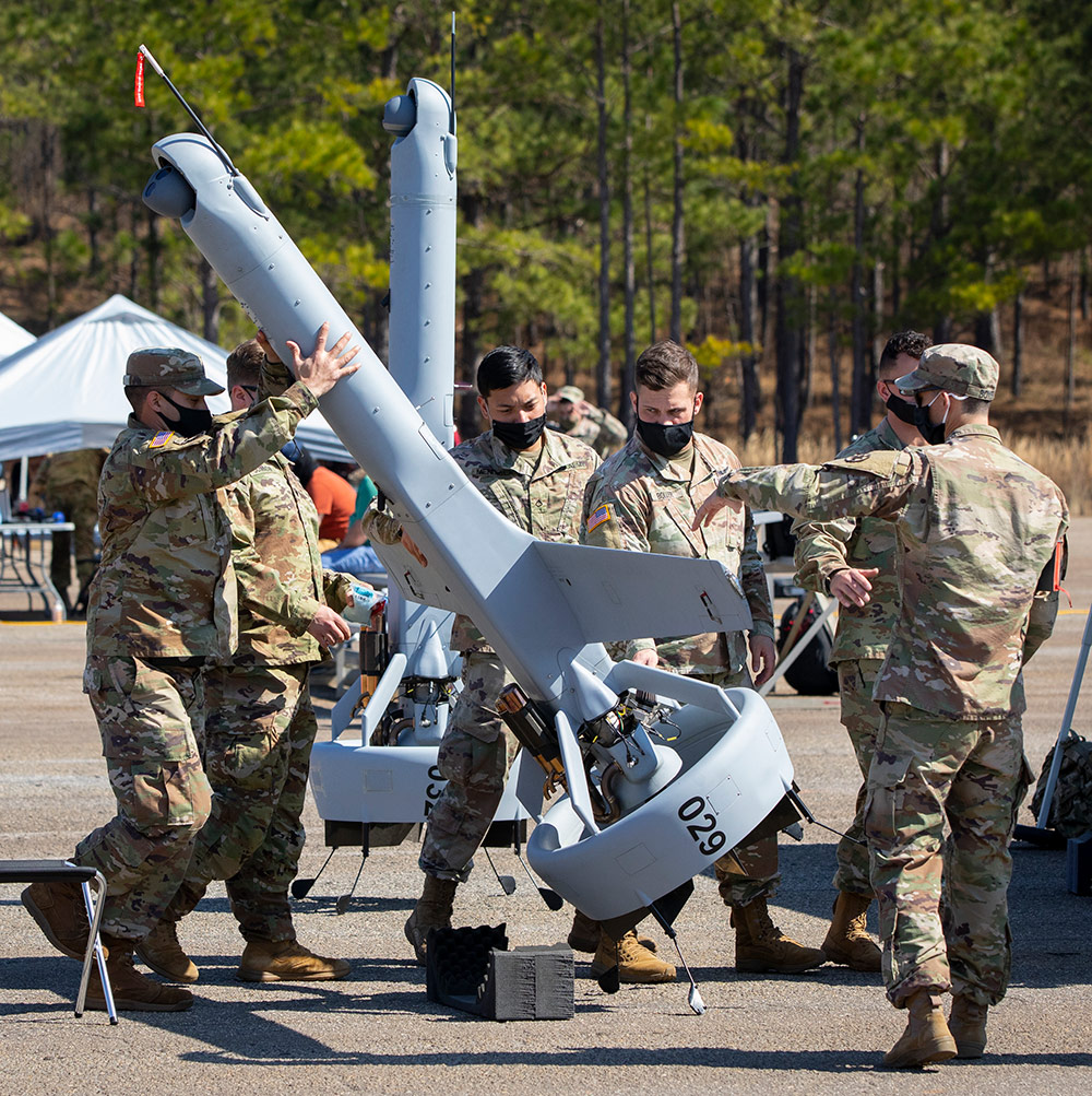 soldier lifting an unmanned aerial vehicle