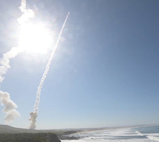Nuclear Deterrence missile flying into the sky leaving smoke trail from the ground