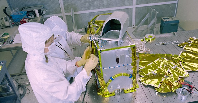 two technicians in cleanroom working on satellite