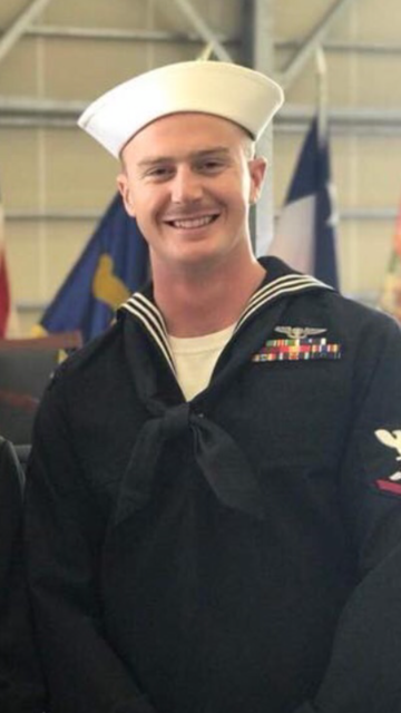 White man in Navy uniform smiles