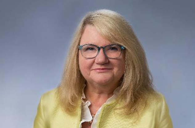 headshot of white woman with blonde hair and glasses