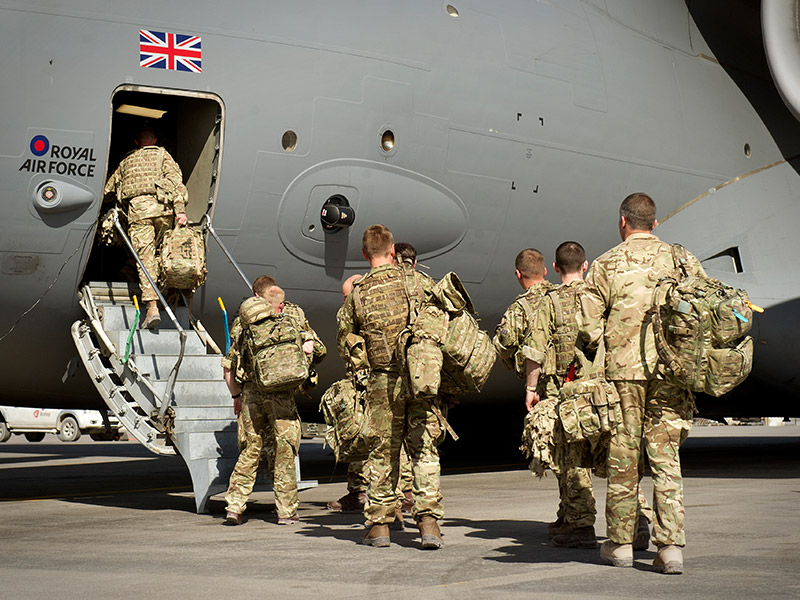 soldiers boarding large military aircraft