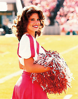 cheerleader smiling on football field