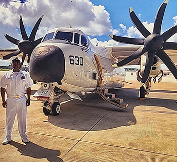 U.S. Navy personel standing infront of aircraft