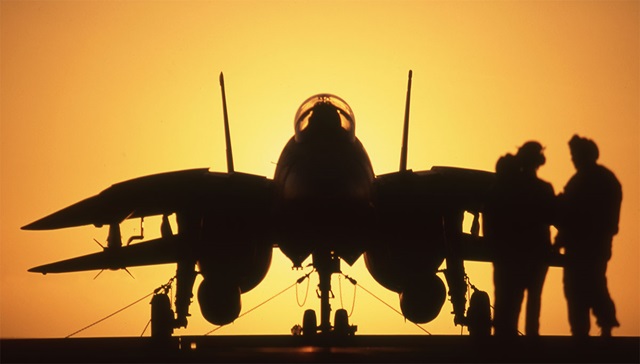 silhouette of two pilots next to F-14 Tomcat
