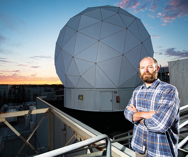 male standing in front of geodesic dome
