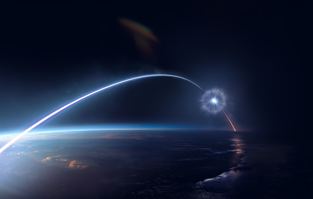 Twilit sky in space with a bright streak arching over Earth’s atmosphere