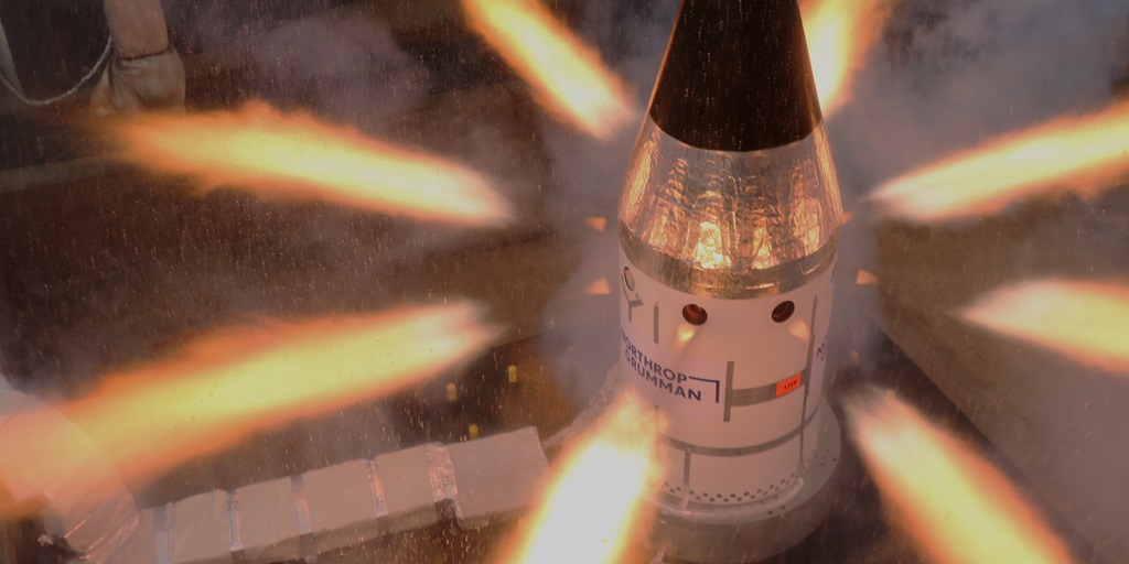 test spacecraft with flames shooting out of the sides