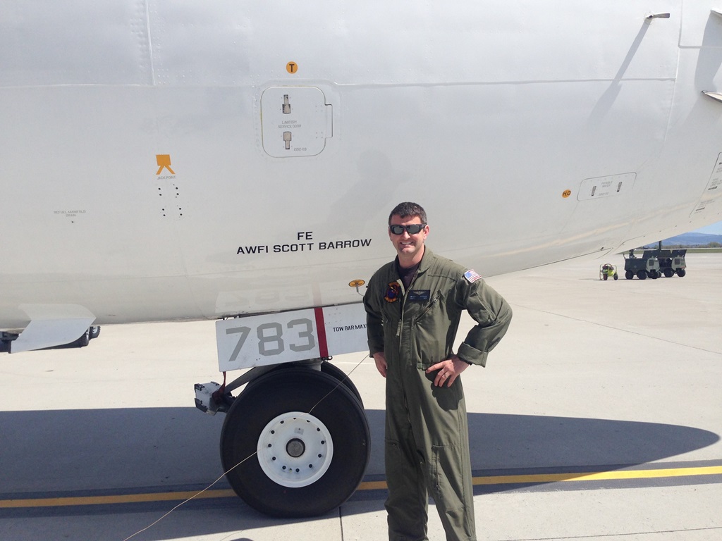 Man in uniform in front of plane