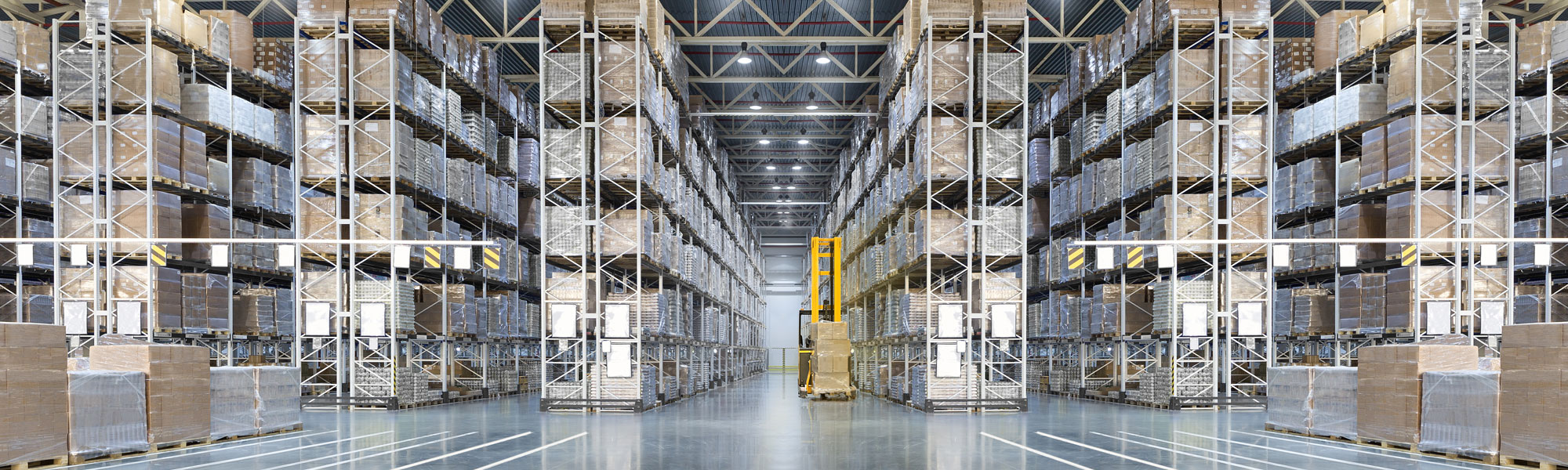 Yellow forklift in large warehouse