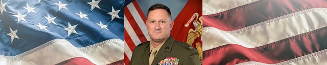 US Marine headshot with american flag in background