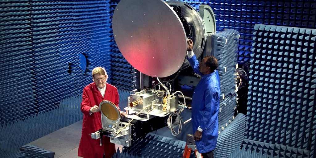 dish in anachoic chamber with two workers in clean suits