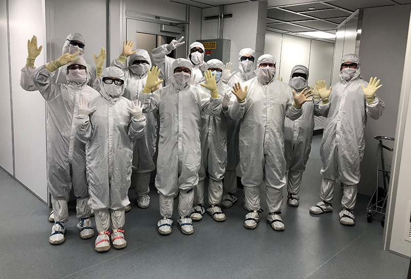 group of employees wearing protective lab suits