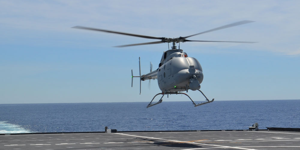 helicopter landing on back of ship in ocean