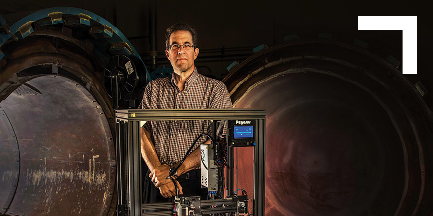 man standing in front of 3D printer