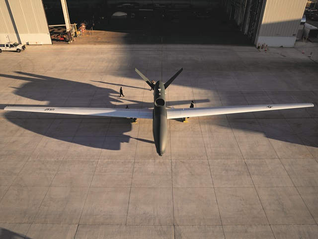 Wide shot photo of aircraft stationed on hangar dock