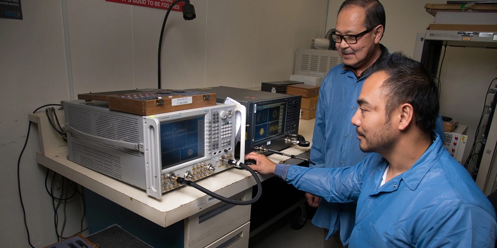 two men working on metrology calibration device