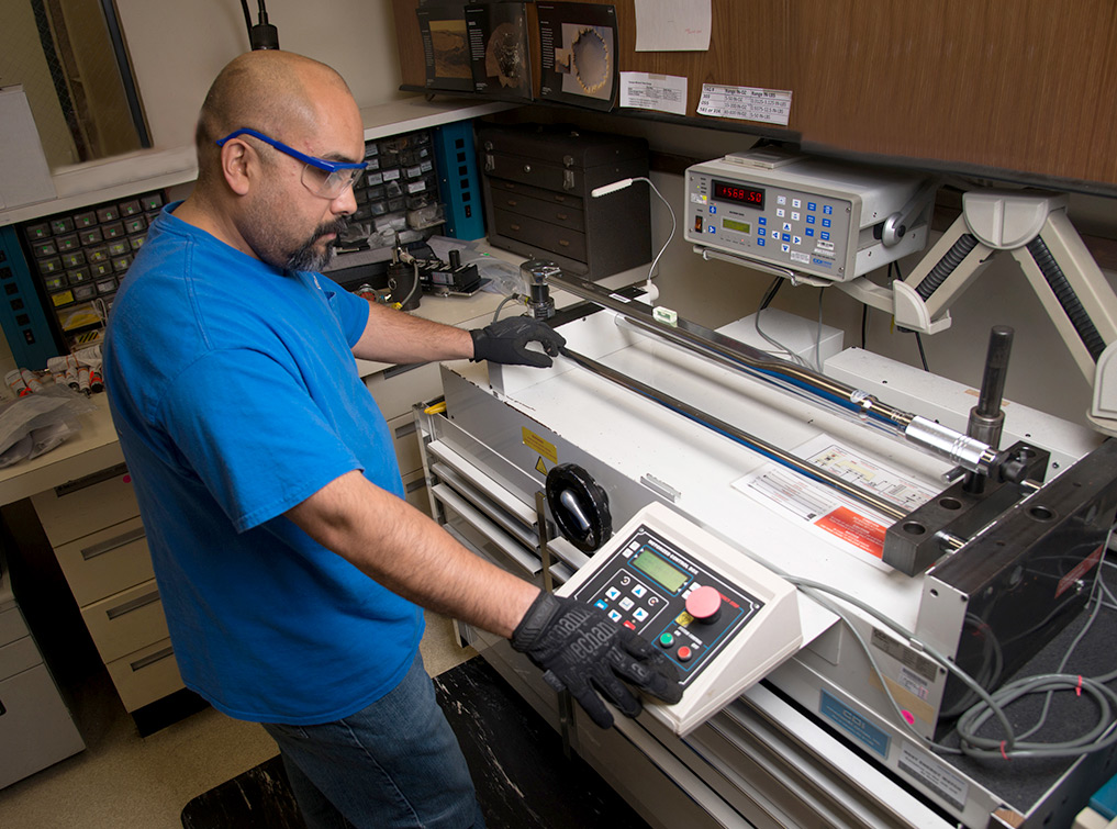 Man working on metrology calibration devices