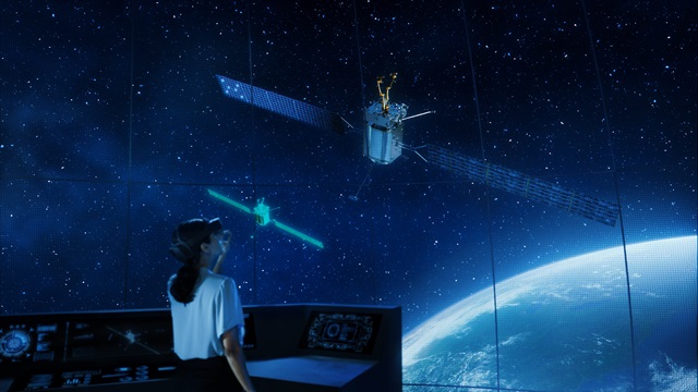 woman in a command center observing satellites