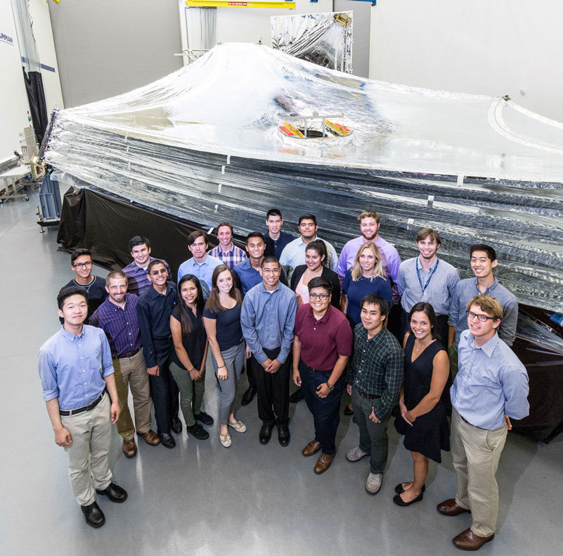 A group of Northrop Grumman interns gather at the James Webb Space Telescope Sunshield